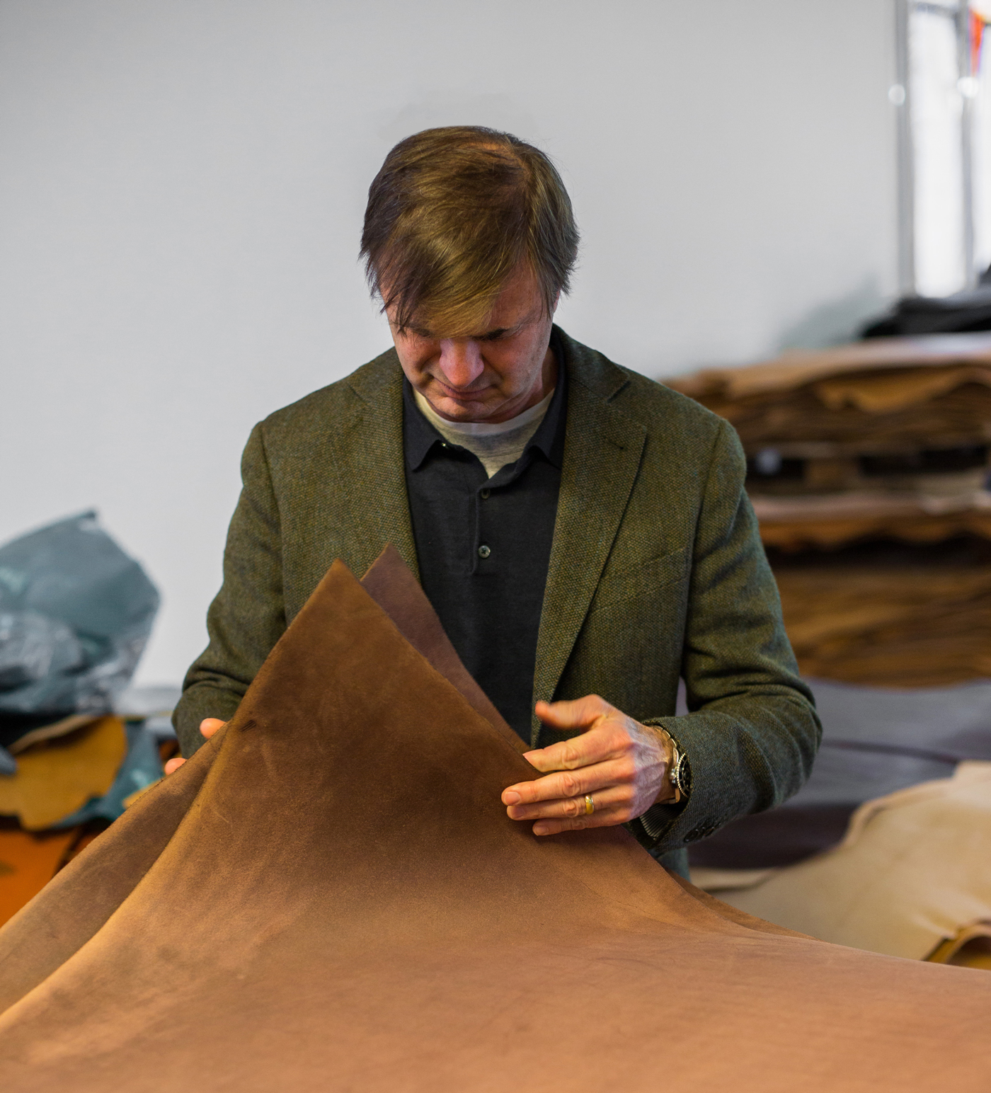 Christopher Bosca inspects leather