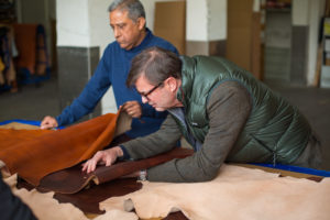 Owner Chris Bosca examines leather samples with our partners in Florence, Italy