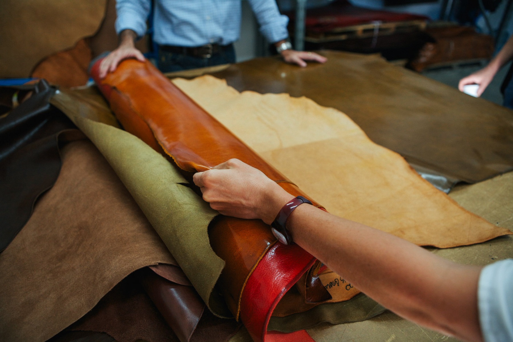 Evaluating experimental leathers at one of our production facilities in Tuscany